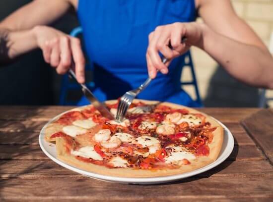 British eat pizza with a knife and fork